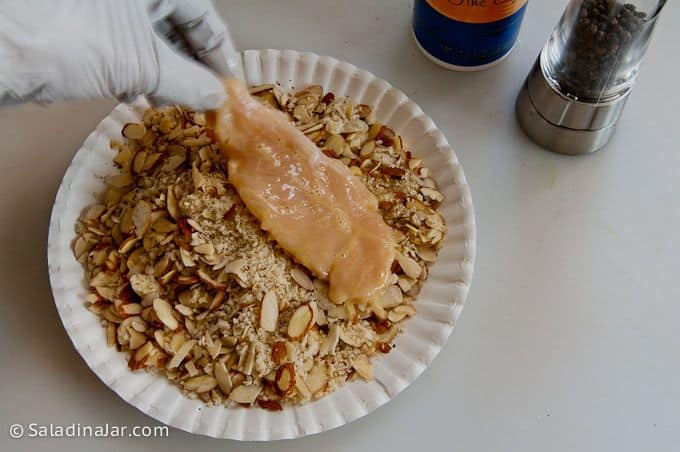 coating tenderloins with almond and bread crumb mixture