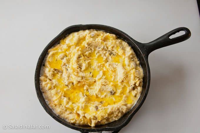 brushing butter over the top of cornbread