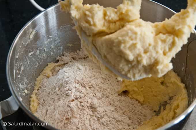 Adding the dry ingredients to the mixing bowl.