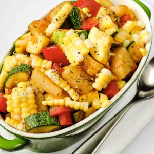 calabacitas with potatoes served as a side dish with spoon on the side.