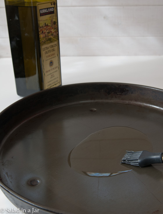 brushing pizza pans with oil