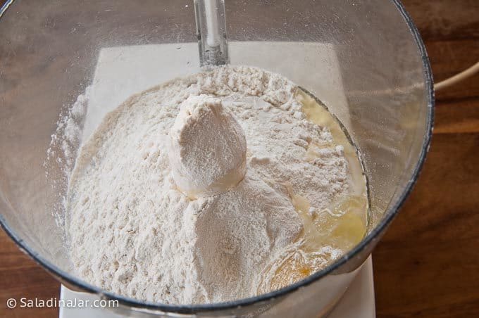Adding dry ingredients to bowl of a food processor