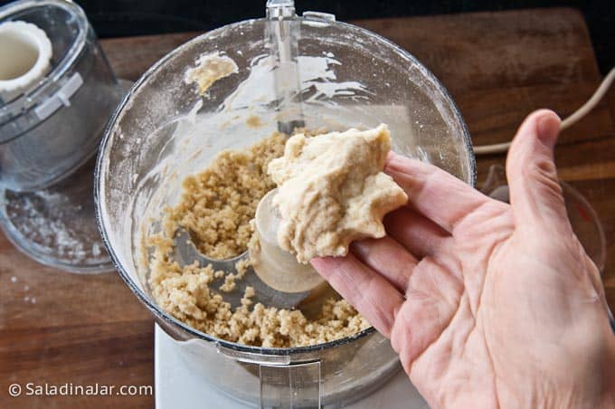 checking the dough with your fingers for consistency.