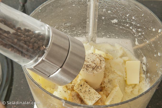 Adding butter and freshly ground pepper