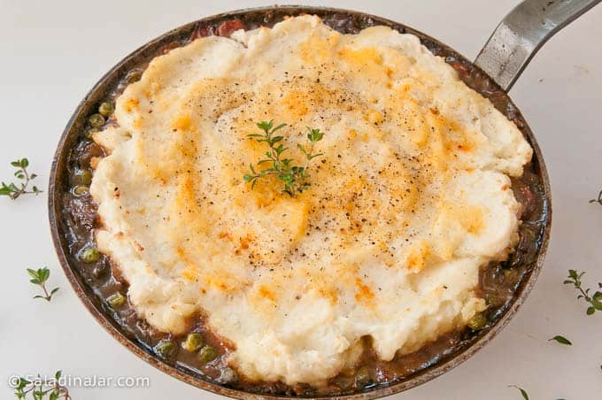 Easy Shepherd's Pie in a skillet, garnished with fresh thyme