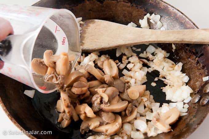 adding mushrooms to onions
