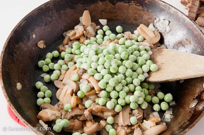 adding peas to mushrooms