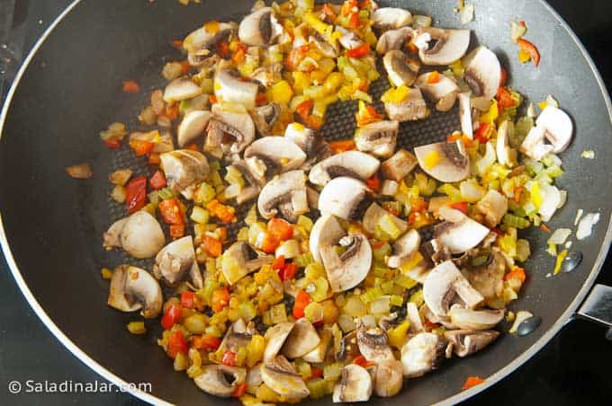 softening onions, peppers, celery, garlic, sage and mushrooms