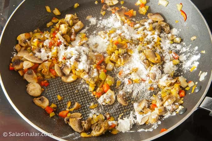 sprinkling flour over veggies