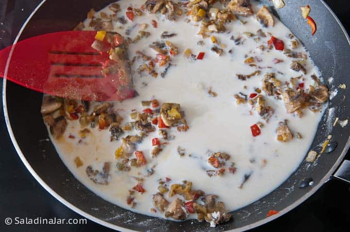 adding milk to the skillet