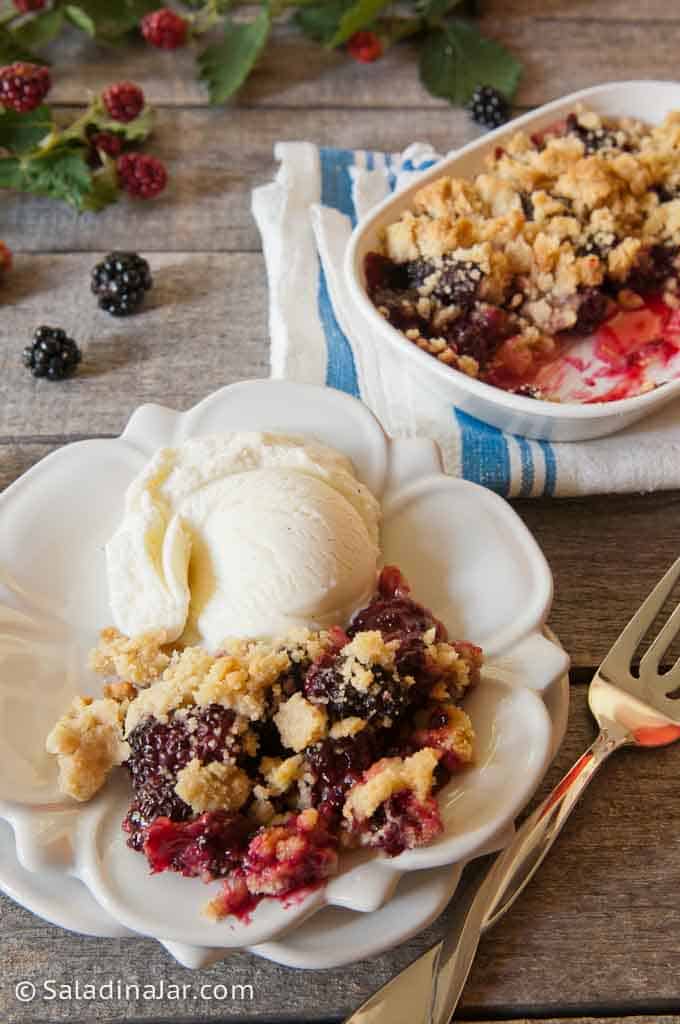 Speedy Blackberry Cobbler with an Easy Shortbread Crust on a plate with ice cream