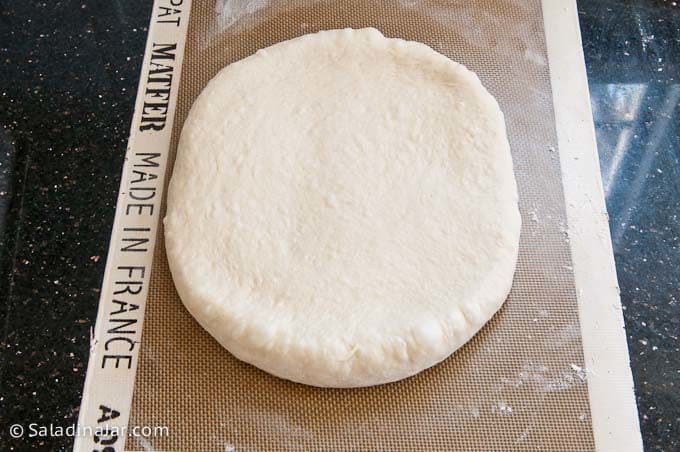 Rolling out dough into a rectangle.