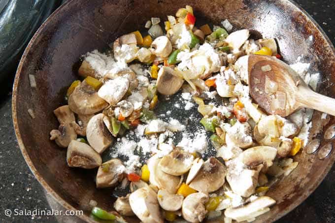 sprinkling flour over veggies.