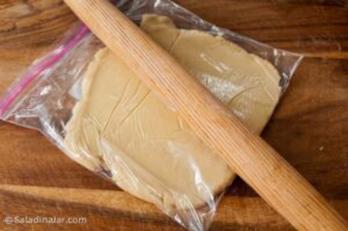 rolling out shortbread cookie dough inside a Ziplock bag.