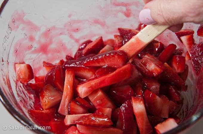 folding strawberries in to the glaze