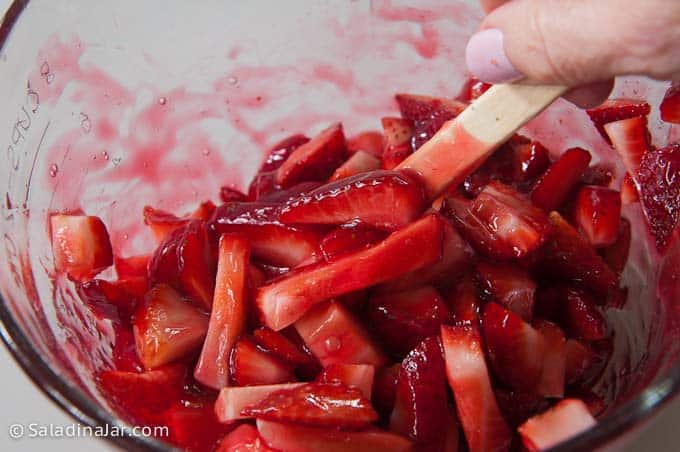 folding strawberries in to the glaze