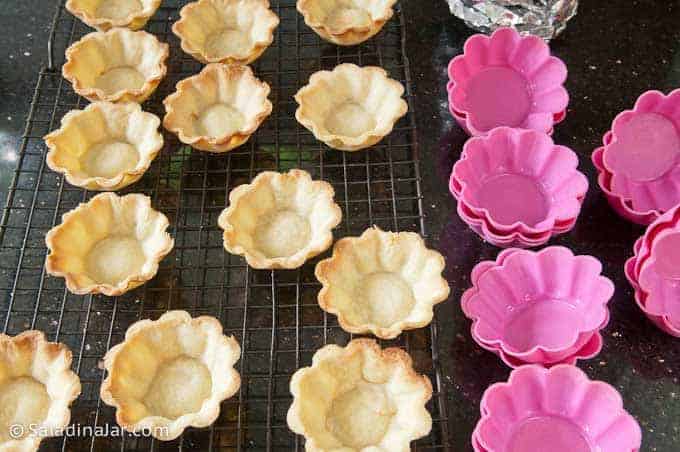 baked mini tart shells along with silicone molds