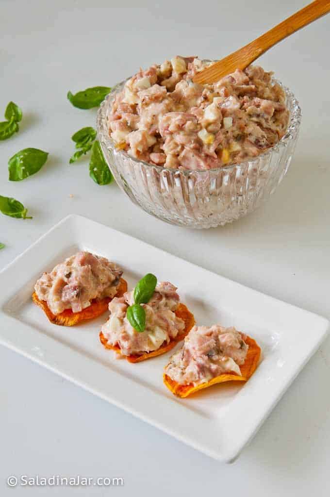 Ham Salad in a bowl with a ham salad on a plate served on sweet potato chips.