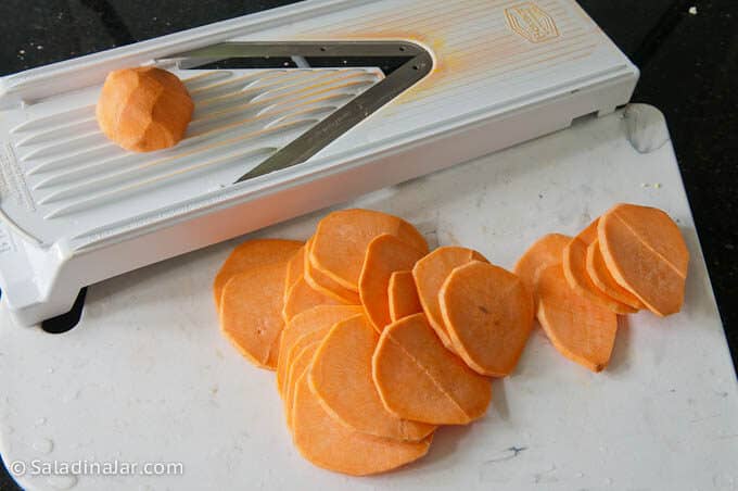 slicing sweet potato chips with a mandoline
