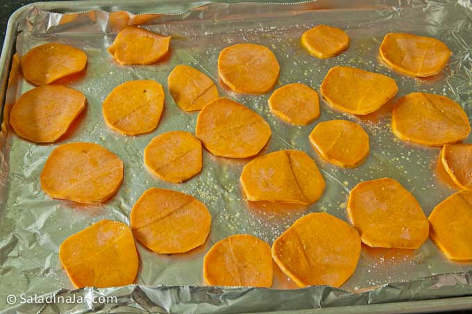 Sweet potato chips baking on cookie sheet