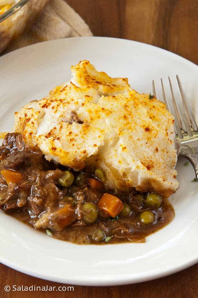 individual serving of Shepherd's pie on a plate with a flork