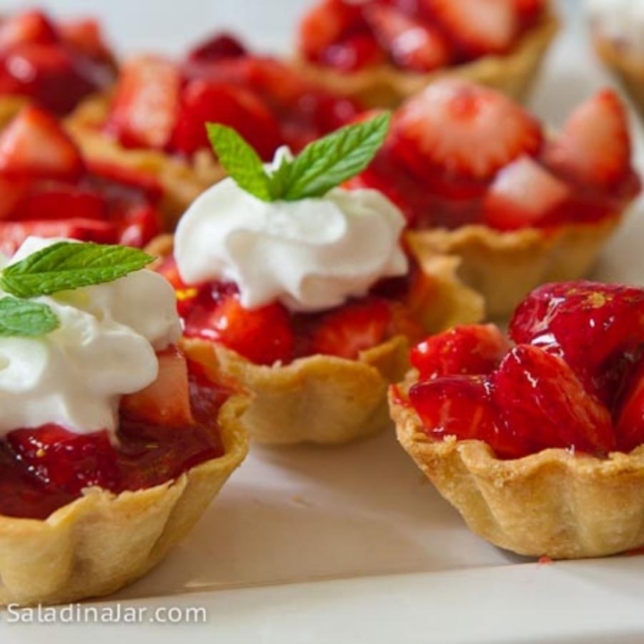 mini strawberry tarts with whipped cream and mint