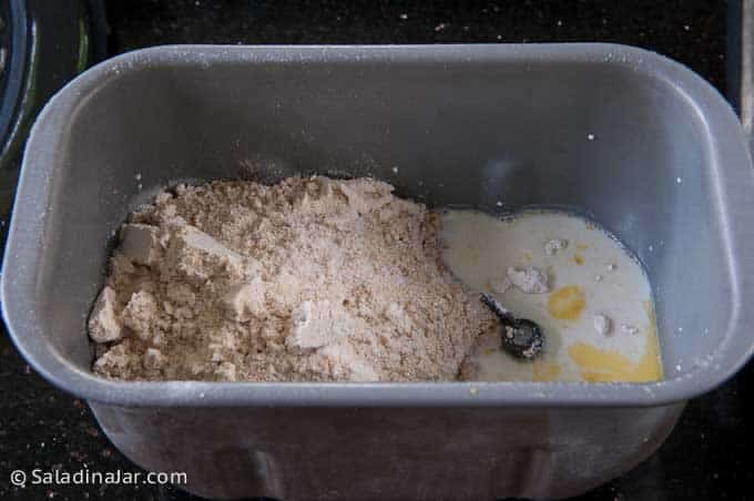 adding ingredients to a bread machine