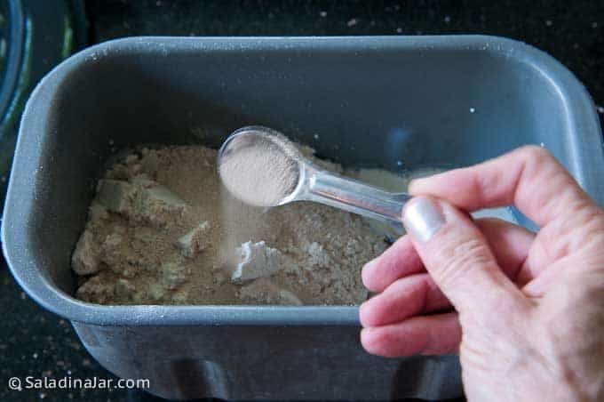 adding ingredients to a bread machine pan