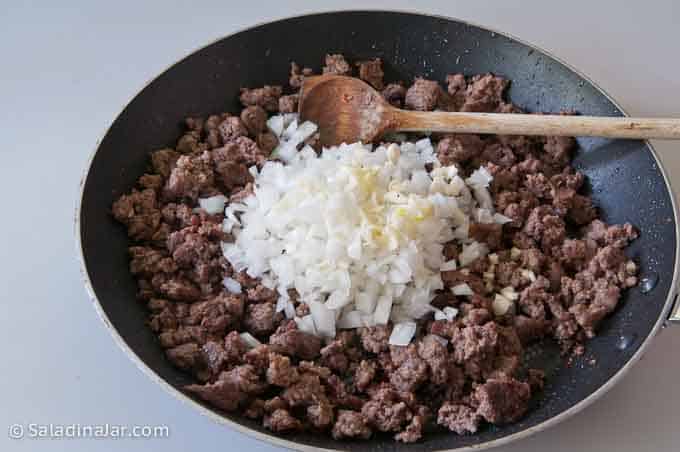 adding onions and garlic after ground beef is browned