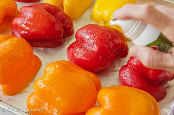 spraying bell peppers before roasting