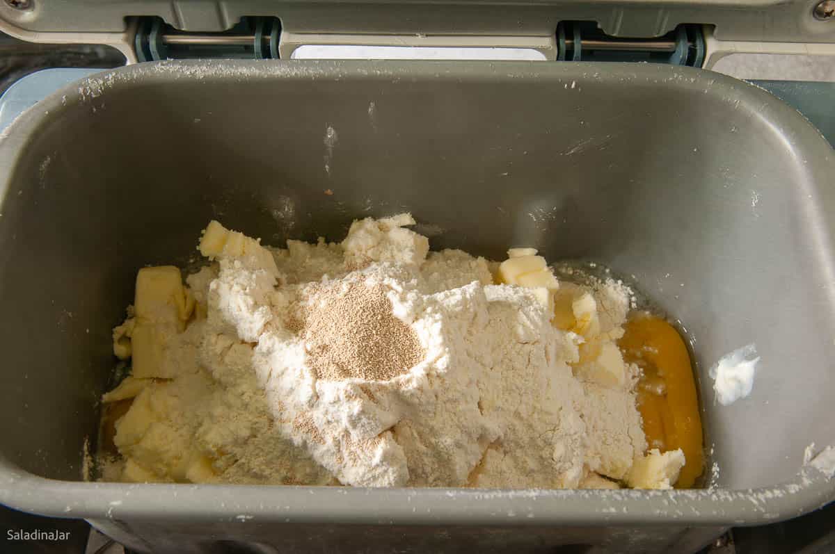 adding all ingredients to the bread machine pan