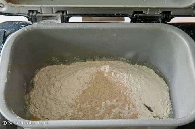 adding flour and yeast to bread machine pan