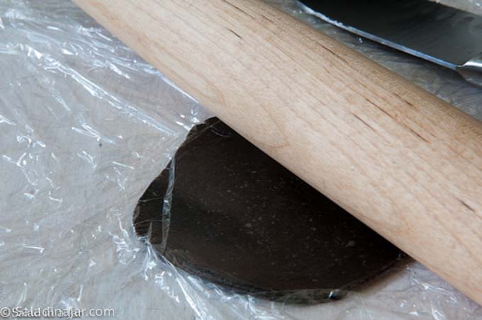 using a rolling pin to roll out pie dough.