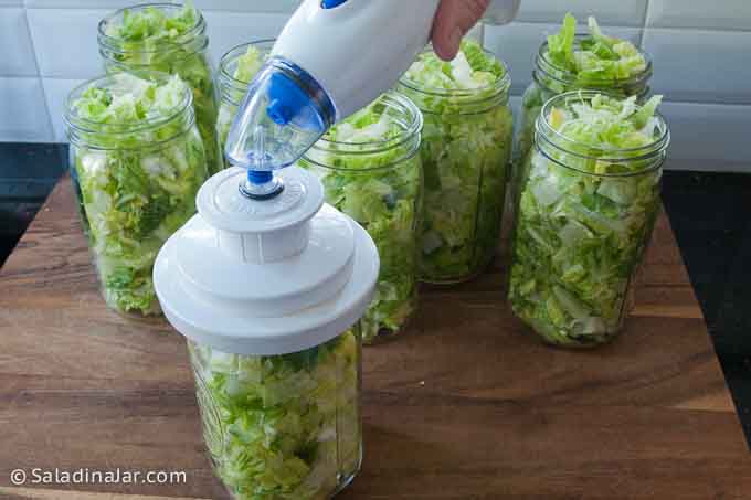 vacuum-packing a jar of chopped lettuce with a portable device