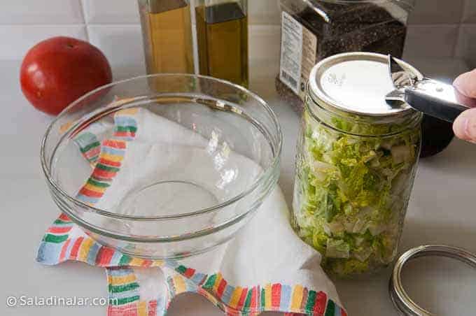 Opening a jar of vacuum-sealed lettuce