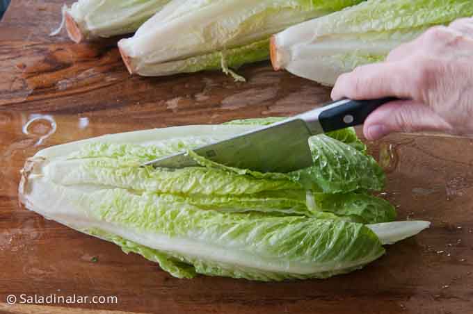 slicing lettuce with a knife.
