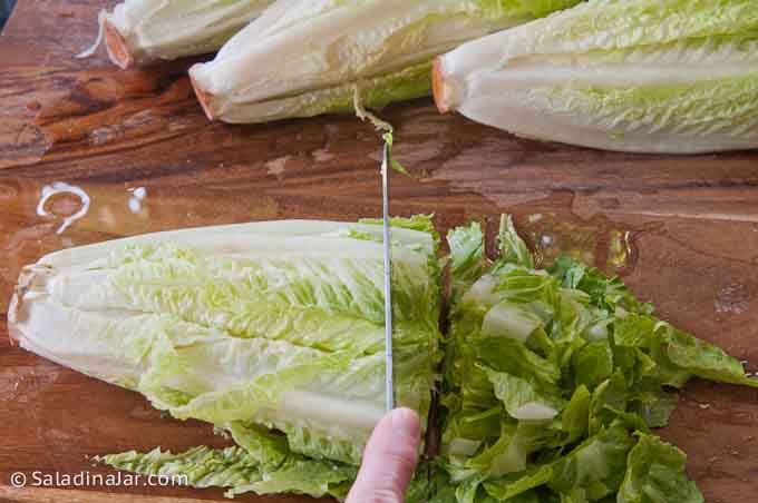 slicing lettuce into small pieces