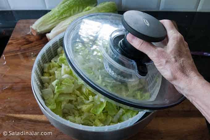 putting lid on a salad spinner.