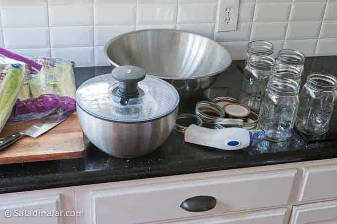 romaine lettuce, salad spinner, large bowl for cut lettuce, Mason jars and a portable vacuum packing device