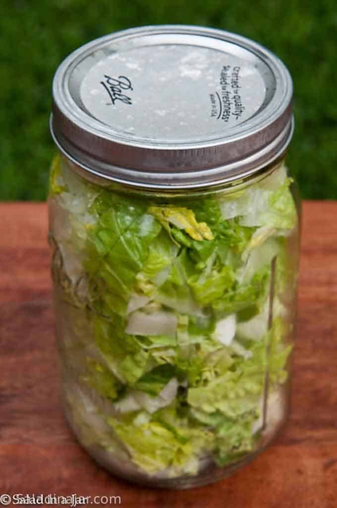 5 Mason Jars Stars For Your Kitchen - showing lettuce vacuum-packed in a glass Mason quart jar.