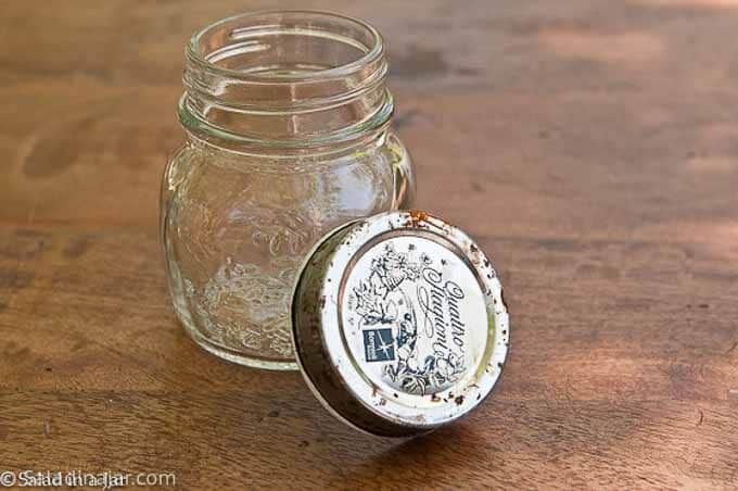 Small glass jar with a rusty lid