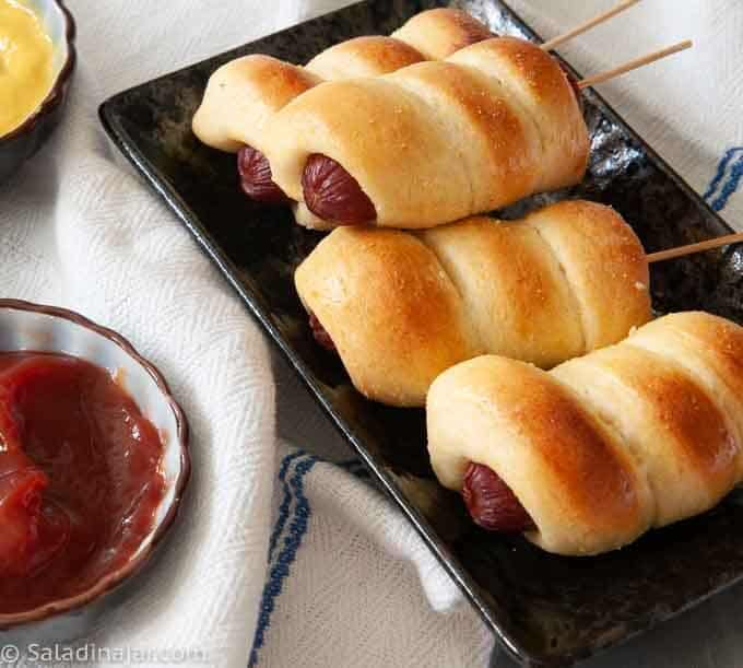 mini baked corndogs with mustard and catsup for dipping
