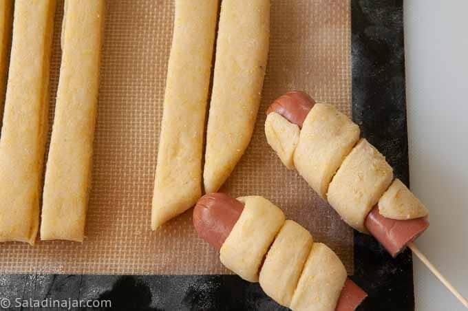 wrapping corndogs with yeast cornbread dough