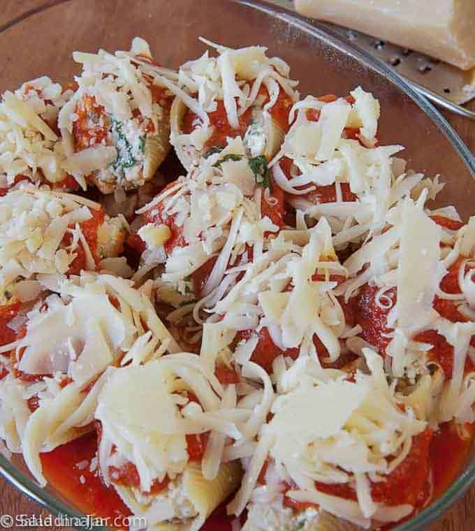 Shells with cheese on top before baking.