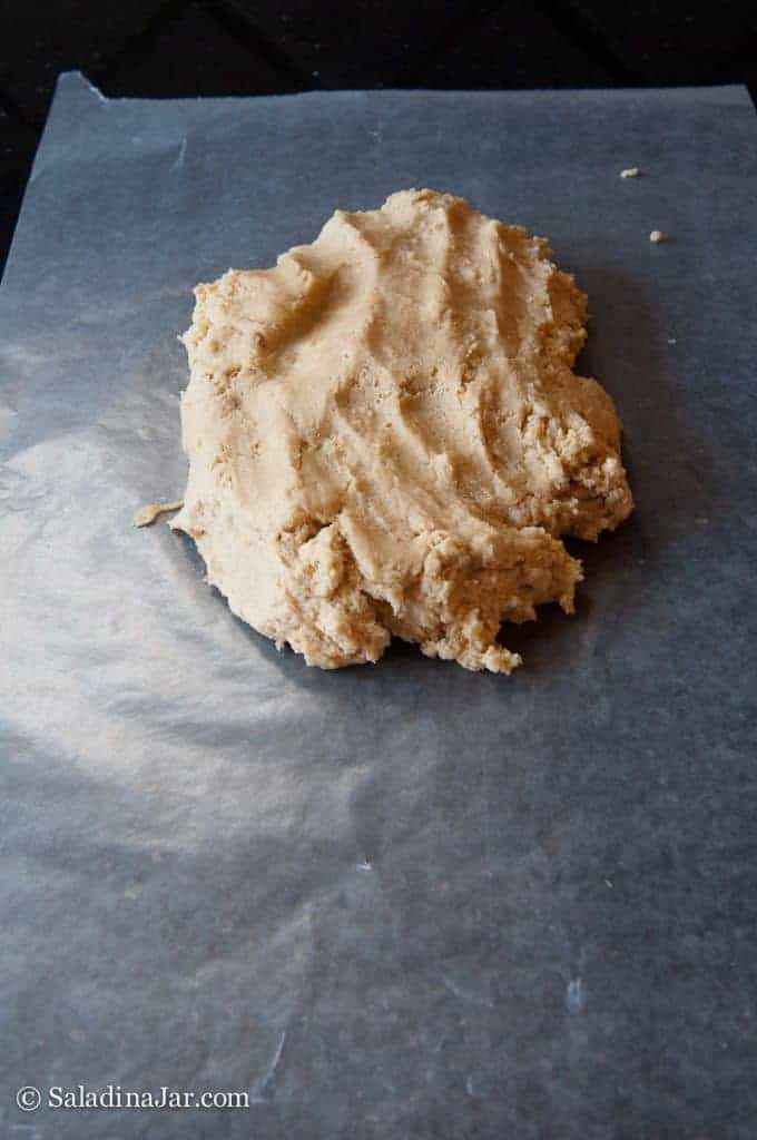 mixed cookie dough transferred to a sheet of wax paper.