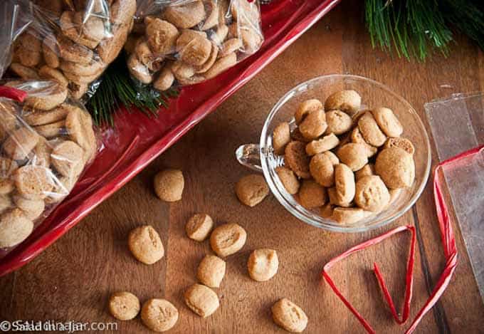 Crunchy Gingerbread Bites in a bowl along with cookies packaged for gift-giving