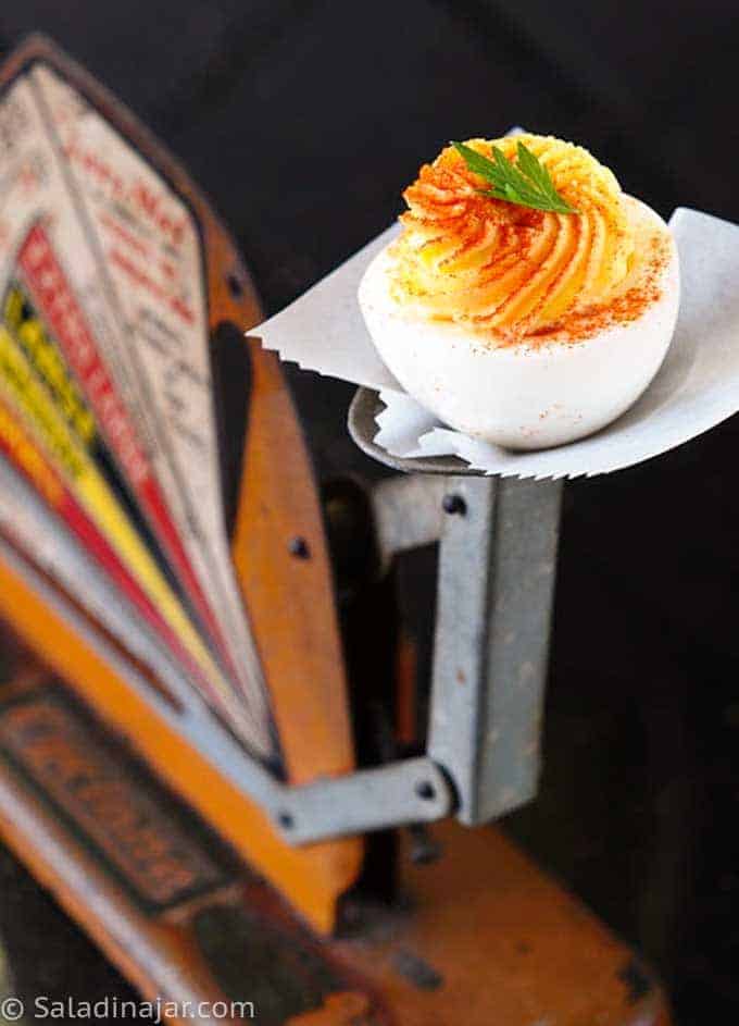 deviled egg displayed on an old-fashioned egg scale