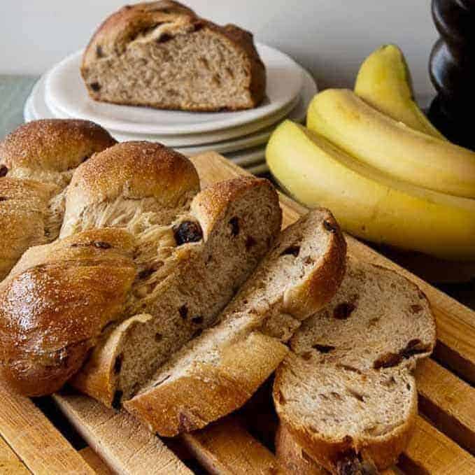 sliced banana-pecan yeast bread with bananas on the side.