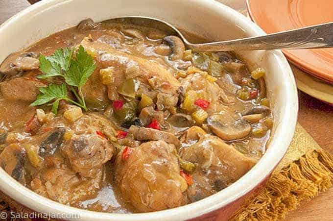 CAJUN Chicken Fricassee AND MUSHROOMS--in serving dish with serving spoon