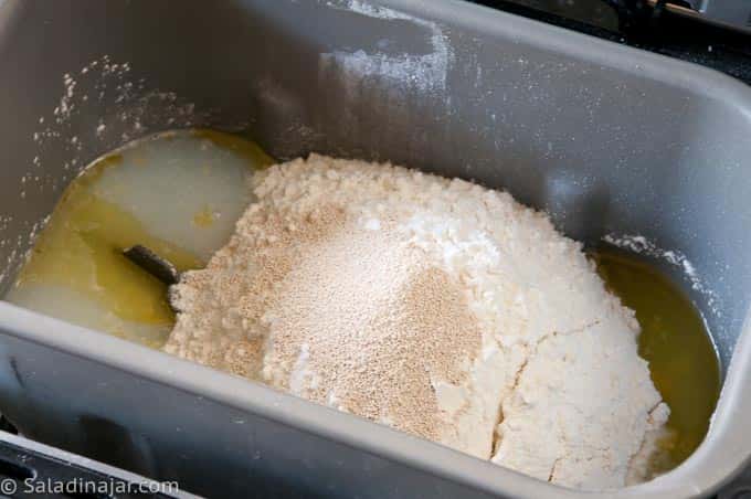 unmixed ingredients in bread machine pan